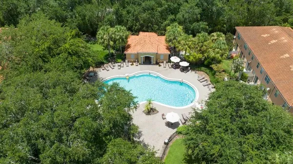 a patio with a table and chairs under an umbrella