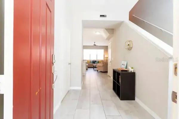 a view of a hallway with living room and furniture