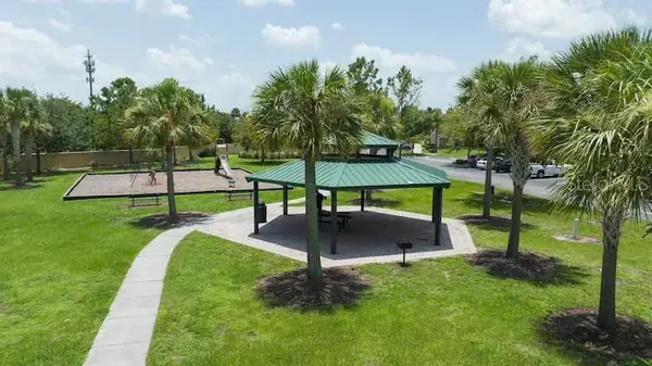 an aerial view of residential houses with outdoor space and trees all around
