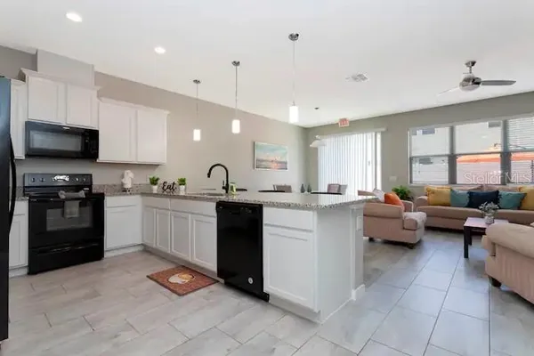 a kitchen with counter top space appliances and a window
