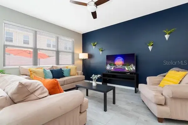 a living room with furniture and a flat screen tv