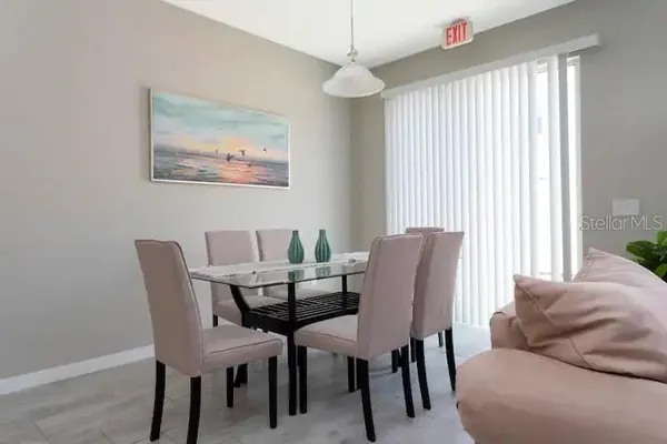 a dining room with furniture and window