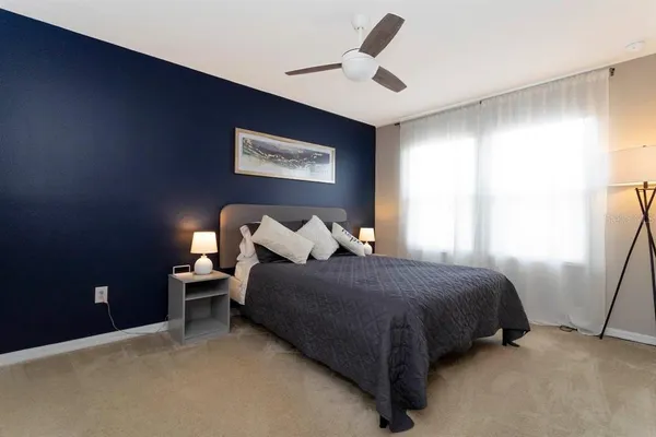 a bedroom with bed and a window