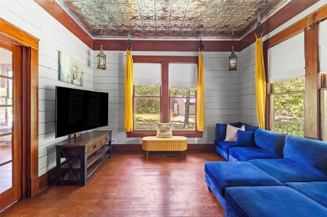 a living room with furniture windows and flat screen tv