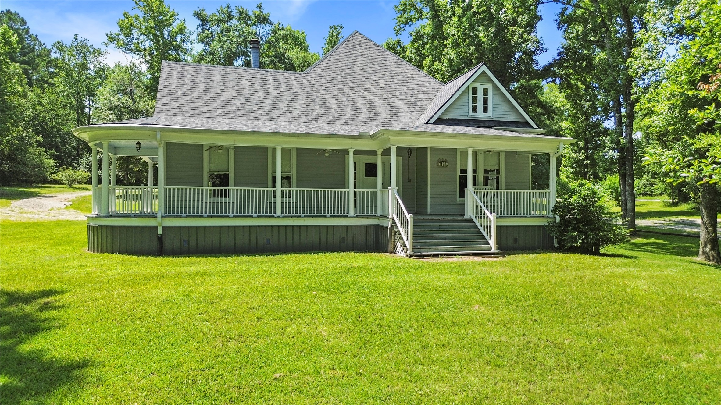 38 Darrell White Road Huntsville, TX 77340 - Photo 2 of 49 a view of a house with a yard patio and a garden