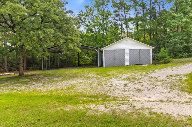 a view of a small house with a yard