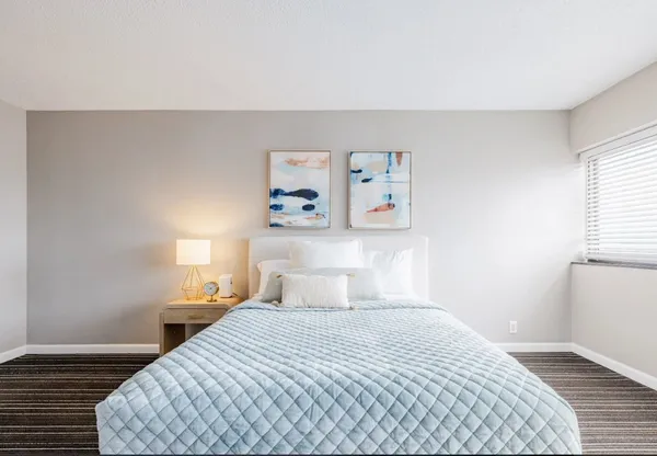 a bedroom with a bed and a window
