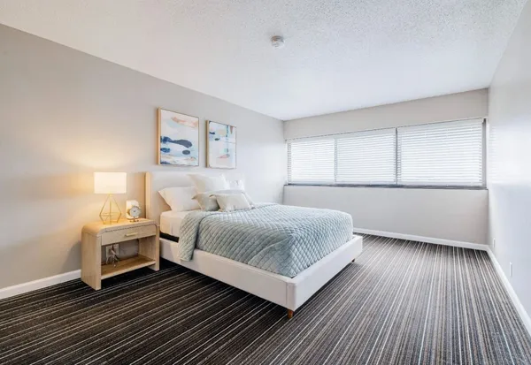a bedroom with a bed and a night stand