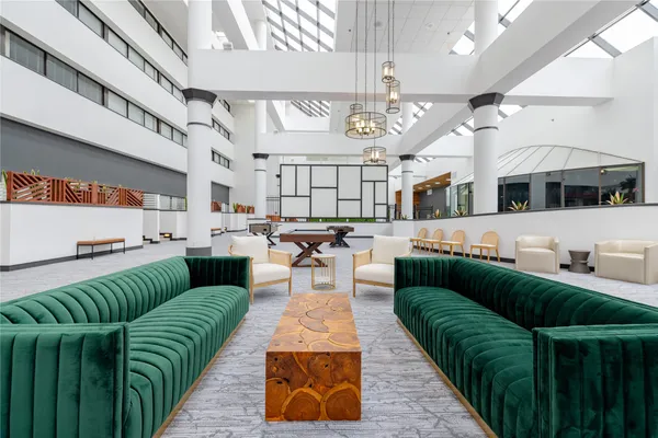 a living room with lots of furniture and kitchen view