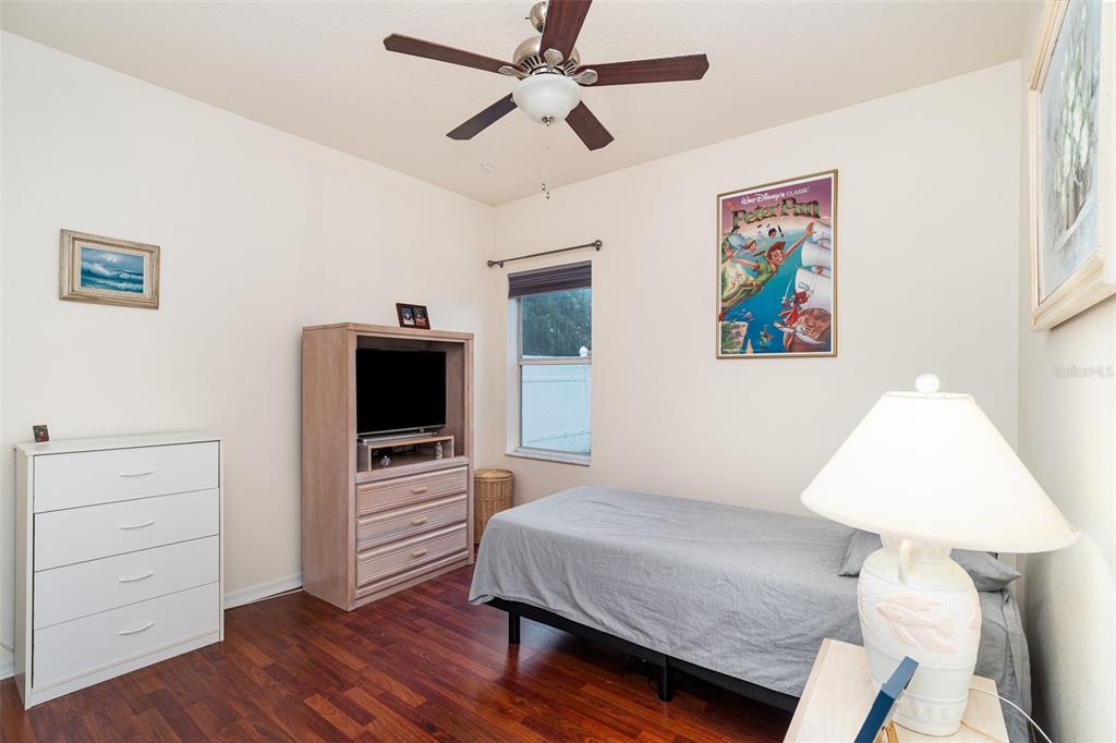 10903 Wildcat Drive Riverview, FL 33579 - Photo 20 of 45 a bedroom with a bed and a flat screen tv