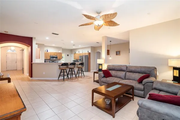a living room with furniture and kitchen view