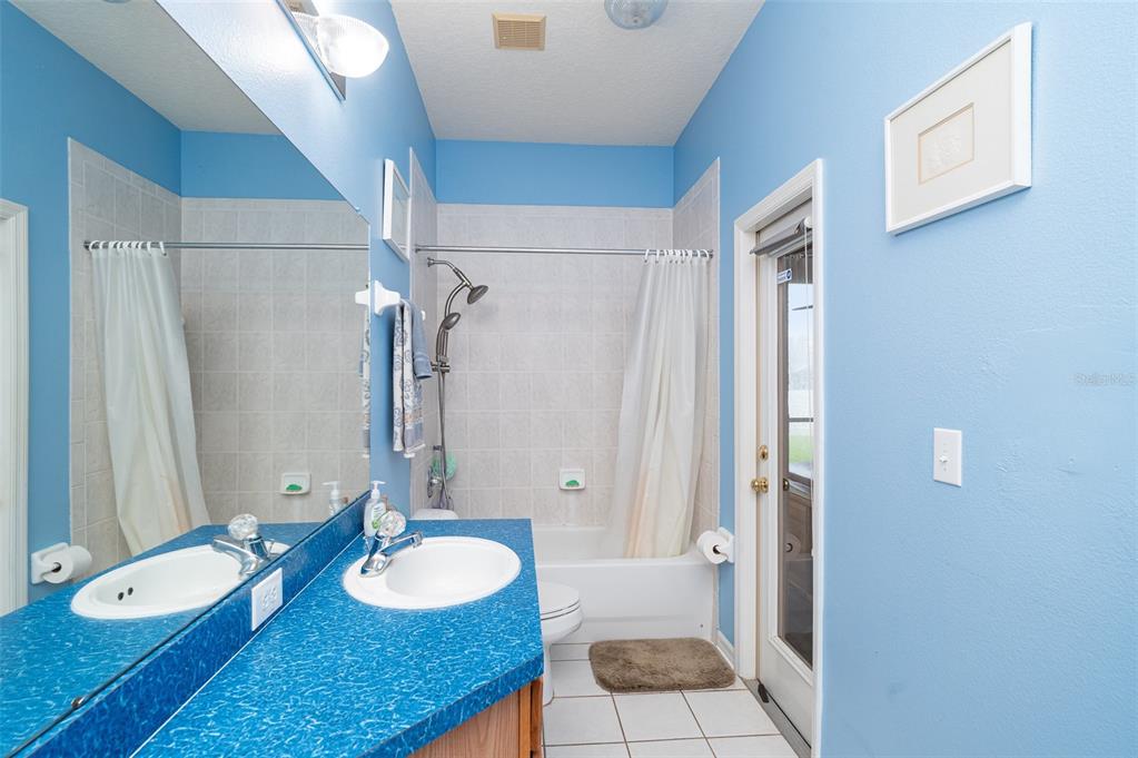 10903 Wildcat Drive Riverview, FL 33579 - Photo 25 of 45 a bathroom with a granite countertop sink and a mirror