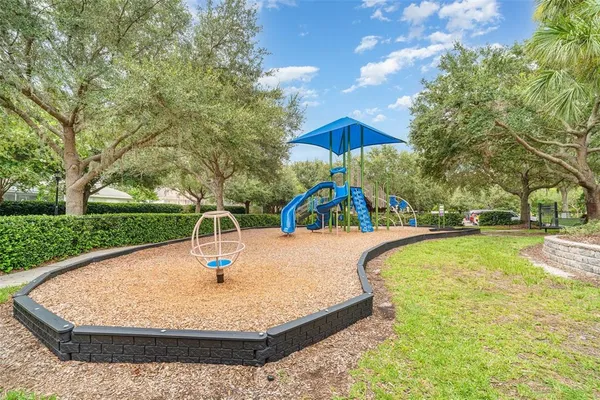 a view of a swimming pool with lawn chairs under an umbrella
