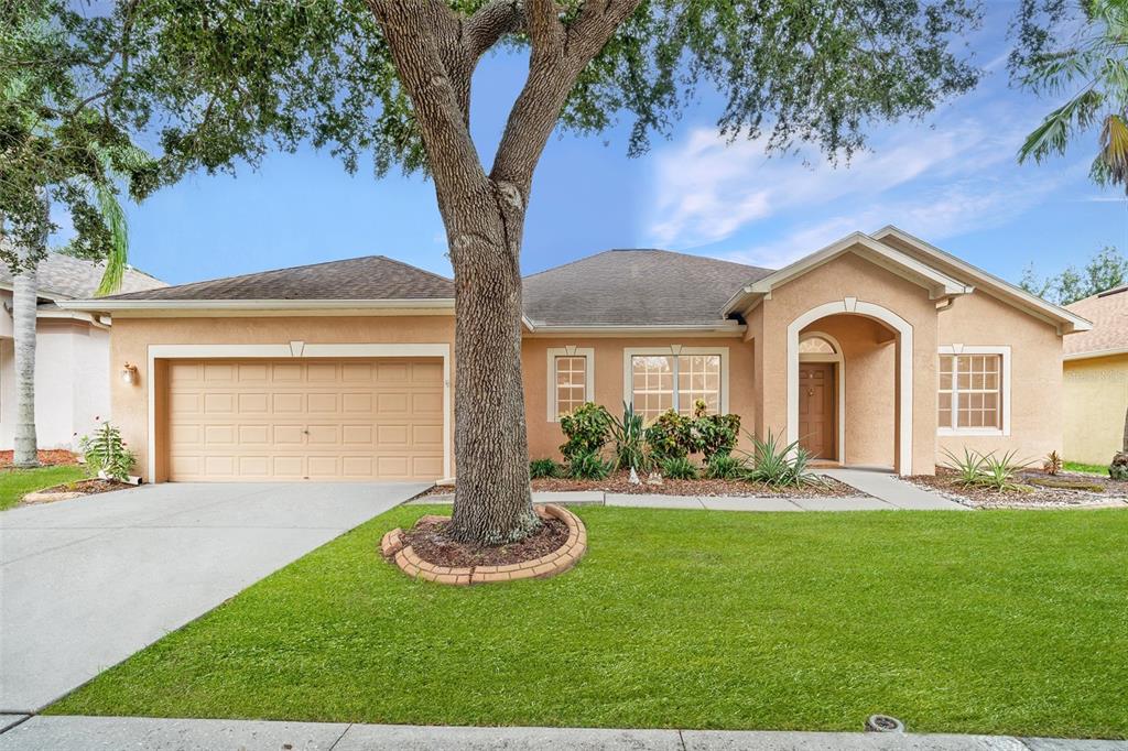 10903 Wildcat Drive Riverview, FL 33579 - Photo 44 of 45 a front view of a house with a yard and garage