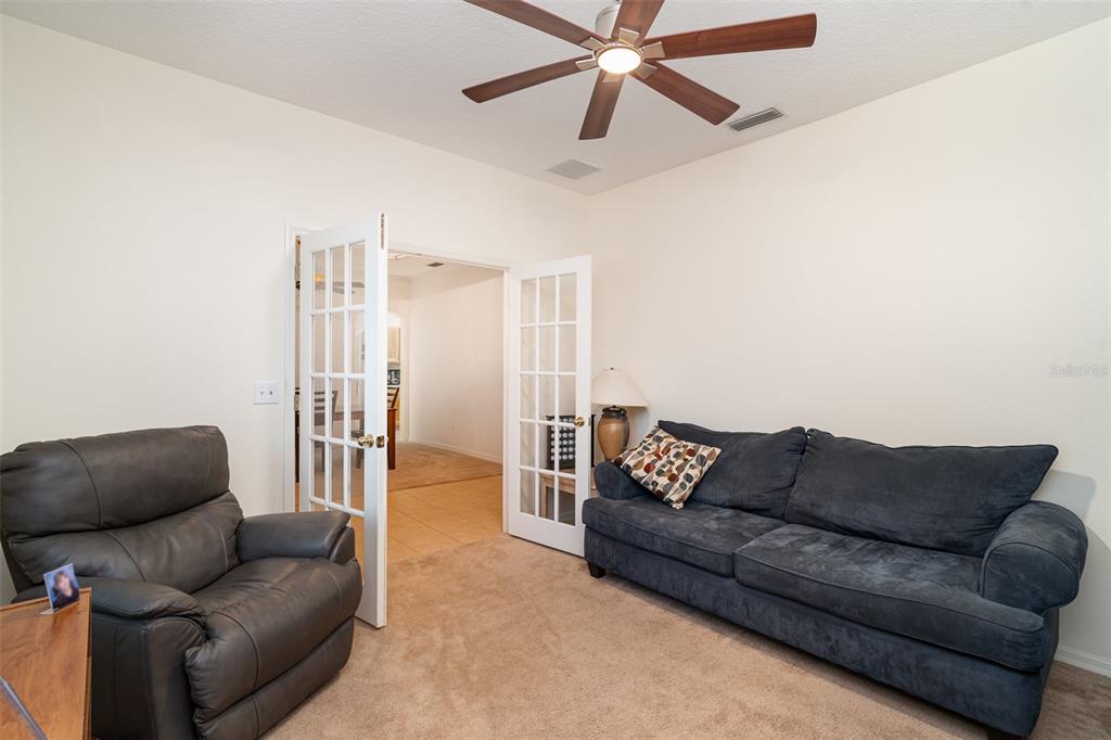10903 Wildcat Drive Riverview, FL 33579 - Photo 5 of 45 a living room with furniture and a ceiling fan