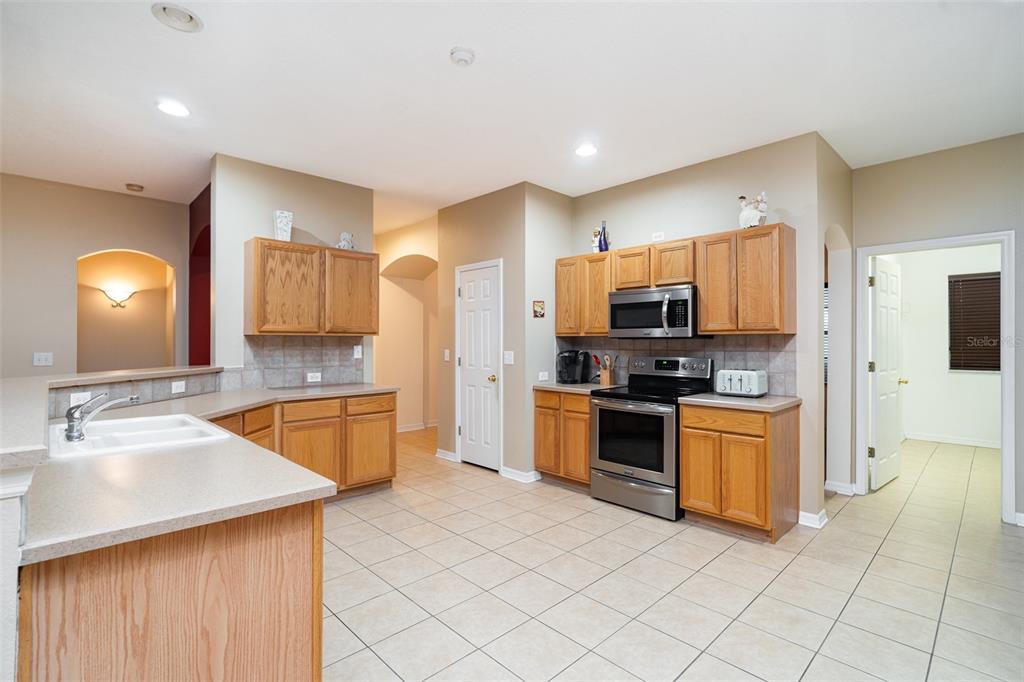 10903 Wildcat Drive Riverview, FL 33579 - Photo 5 of 45 a large kitchen with cabinets and stainless steel appliances