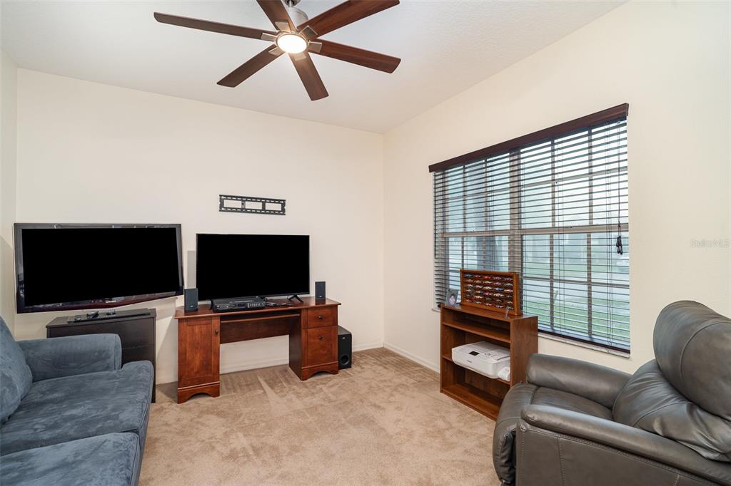 10903 Wildcat Drive Riverview, FL 33579 - Photo 9 of 45 a living room with furniture and a flat screen tv