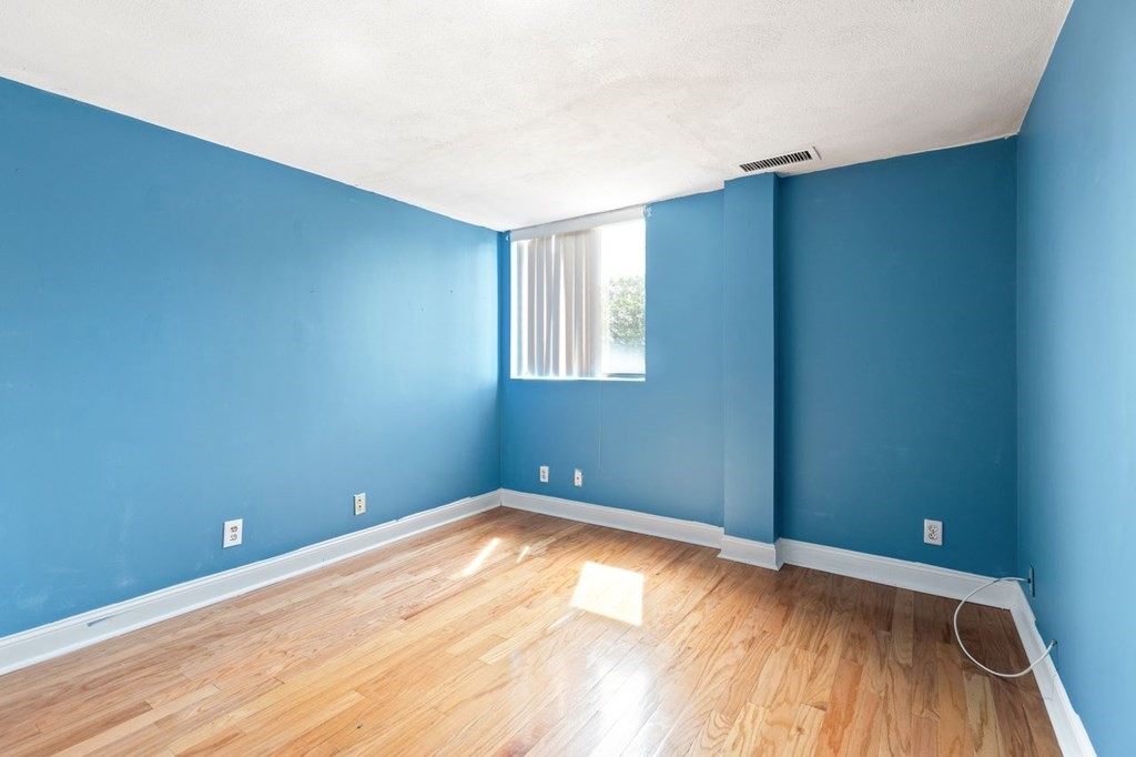 205 Ferry Street, Unit 409 Everett, MA 02149 - Photo 16 of 24 an empty room with wooden floor and windows