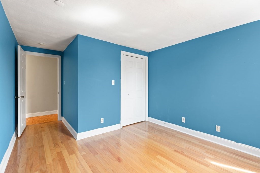205 Ferry Street, Unit 409 Everett, MA 02149 - Photo 17 of 24 a view of a room with wooden floor