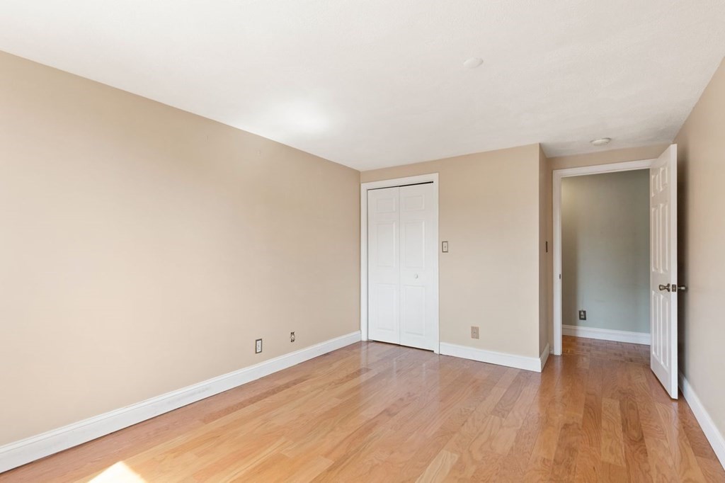 205 Ferry Street, Unit 409 Everett, MA 02149 - Photo 19 of 24 a view of an empty room and wooden floor