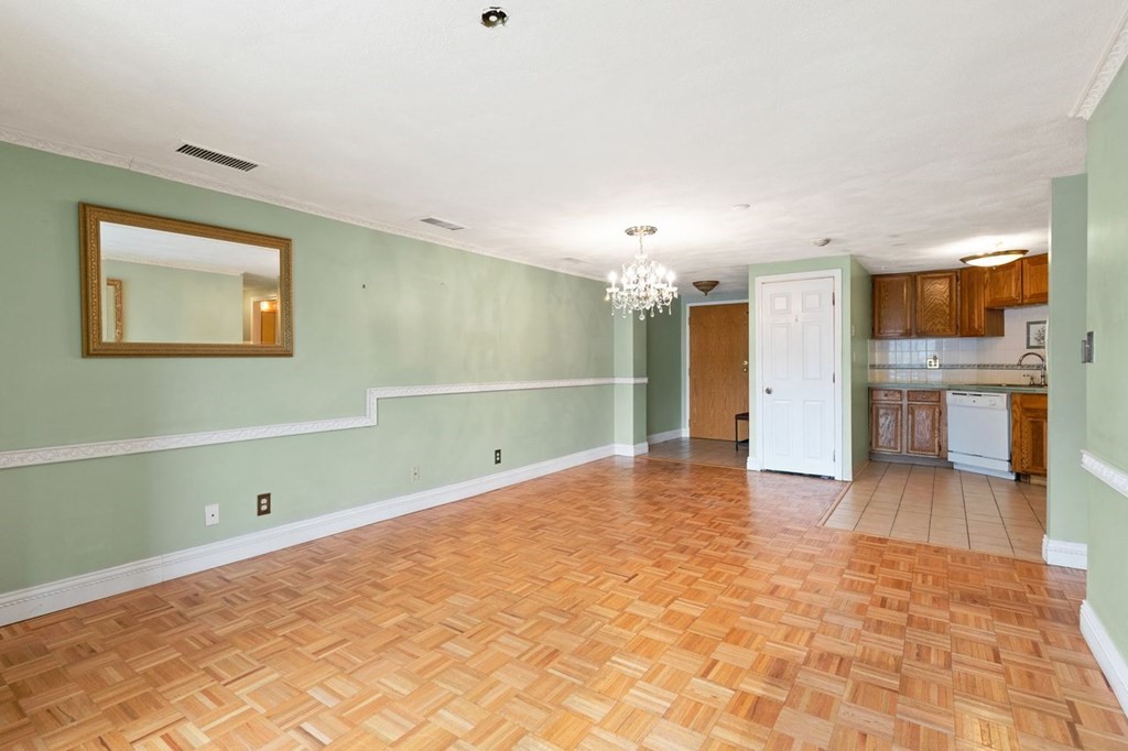 205 Ferry Street, Unit 409 Everett, MA 02149 - Photo 8 of 24 a view of a kitchen with a sink and a refrigerator