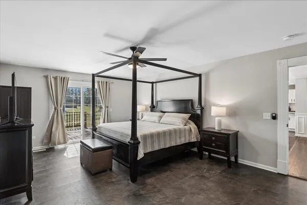 a bedroom with a bed and a flat tv screen