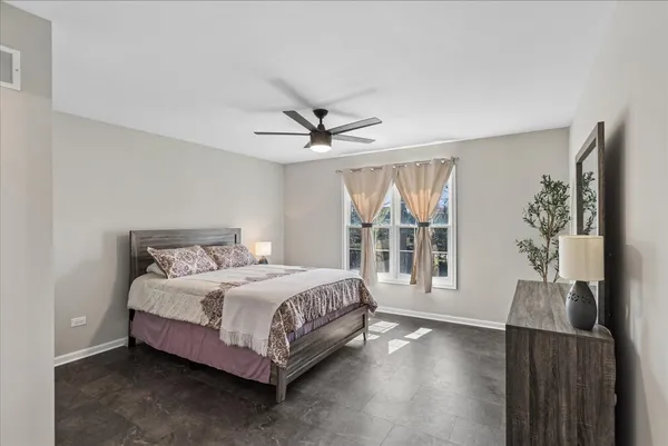 a bed sitting in a bedroom next to a window
