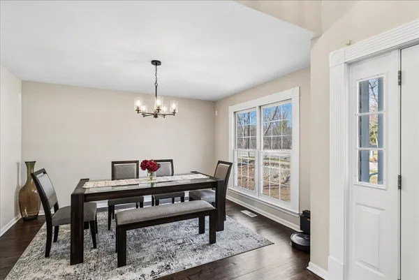 a view of a dining room with furniture window and wooden floor