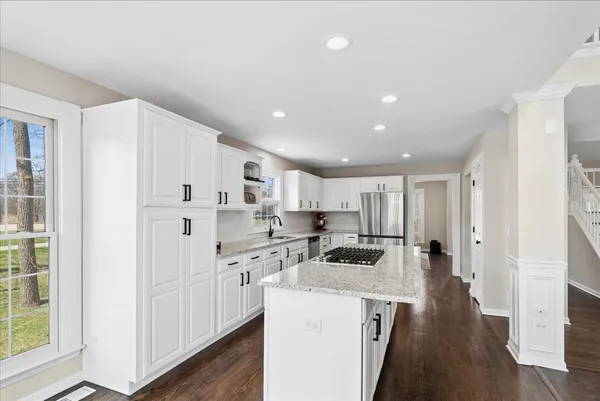 a kitchen with cabinets and wooden floor