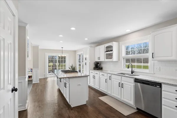 a kitchen with stainless steel appliances granite countertop a sink and cabinets
