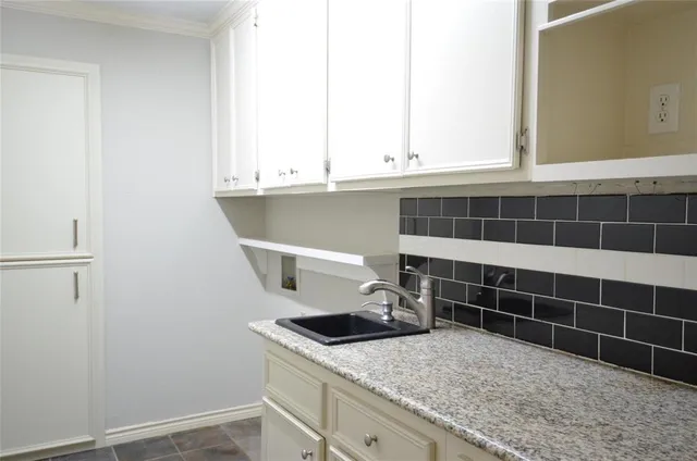 a kitchen with a sink and cabinets