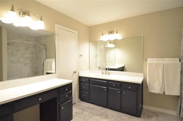 a spacious bathroom with a double vanity sink mirror and