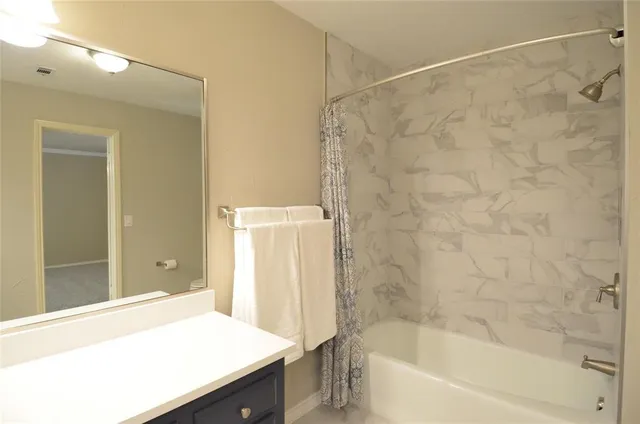 a bathroom with a bathtub and a sink