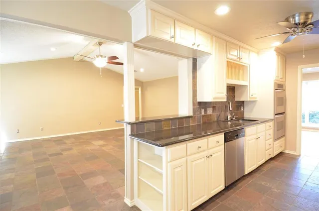 a spacious bathroom with a granite countertop sink and a mirror