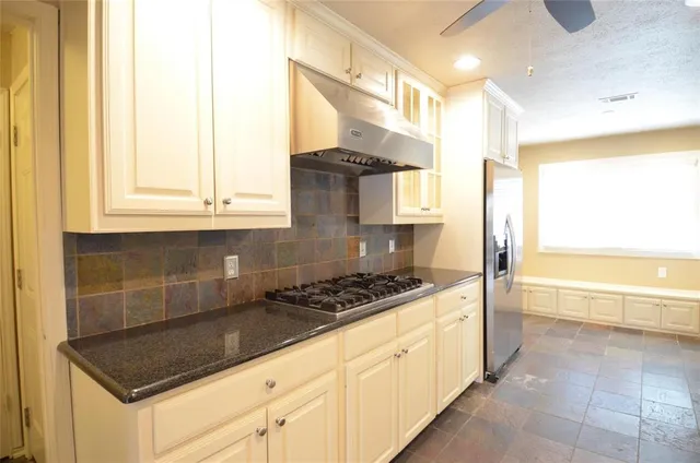 a kitchen with stainless steel appliances granite countertop a sink and a stove