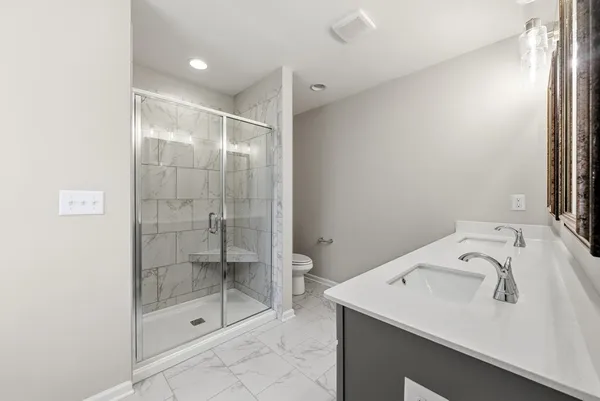 a bathroom with a shower sink and mirror