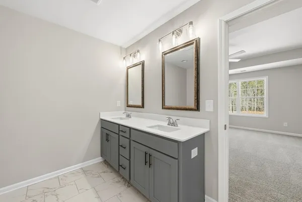 a bathroom with a double vanity sink and mirror