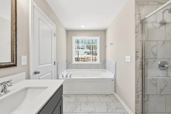 a bathroom with a bathtub and a sink