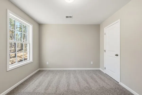 a view of room with window and stairs