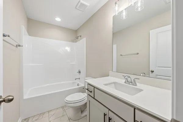 a bathroom with a toilet and a bathtub