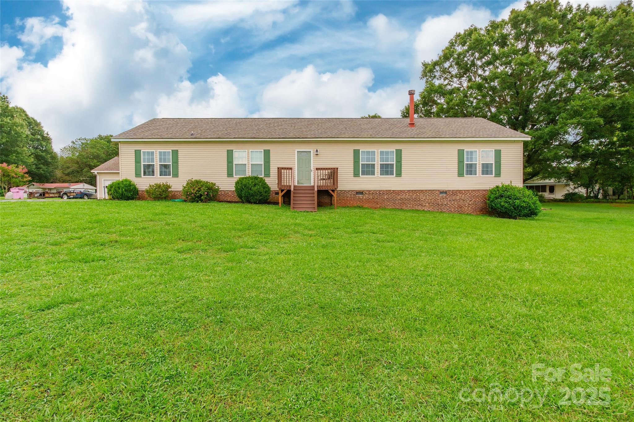 5919 Austin Road Monroe, NC 28112 - Photo 1 of 34 a front view of a house with a garden