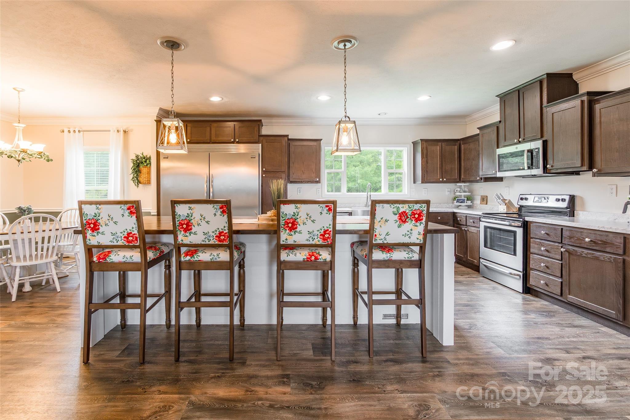5919 Austin Road Monroe, NC 28112 - Photo 8 of 34 a open kitchen with stainless steel appliances granite countertop a stove top oven a sink with island and chairs