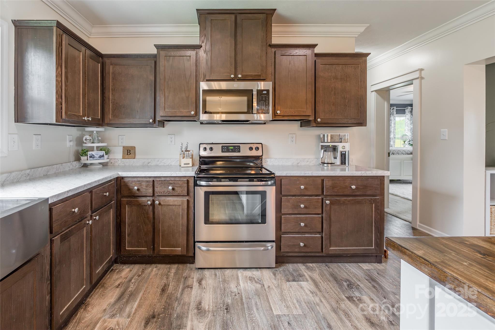 5919 Austin Road Monroe, NC 28112 - Photo 10 of 34 a kitchen with stainless steel appliances granite countertop a stove a sink and a microwave