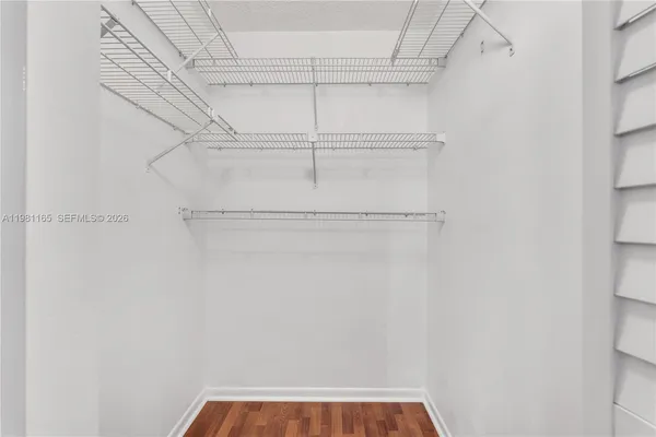 a view of walk in closet with empty racks