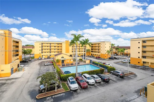 a view of a gym with parked cars