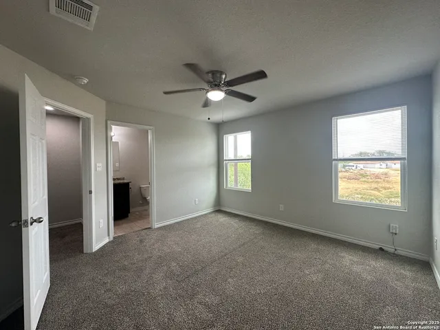 a view of a livingroom with a ceiling fan window and a chandelier