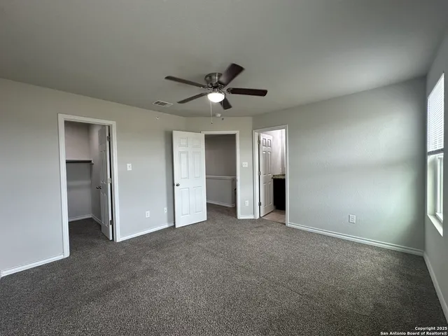 a bathroom with a granite countertop sink mirror vanity and toilet