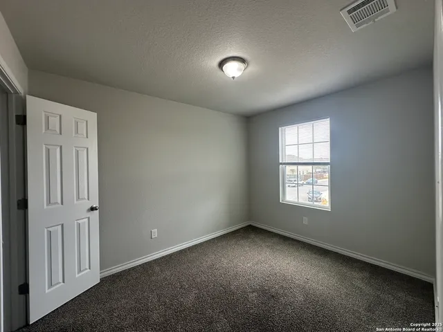 a bathroom with a granite countertop sink a toilet and shower