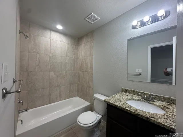 a view of a room with a ceiling fan