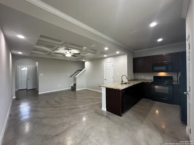 a kitchen with stainless steel appliances granite countertop a refrigerator and a sink